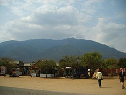 Shops on the main road running through Longido. Mount Longido can be seen behind, however the peak isn't visible from here.