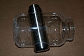 water bottle is to contain ice water and clear jar is to contain hand in a vacuum